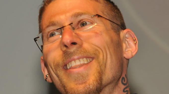 Headshot of poet Benjamin S. Grossberg smiling.