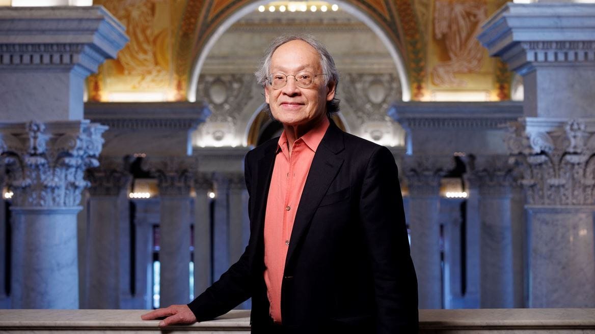 Arthur Sze, an Asian poet, standing on the upper floor of the Library Congress.
