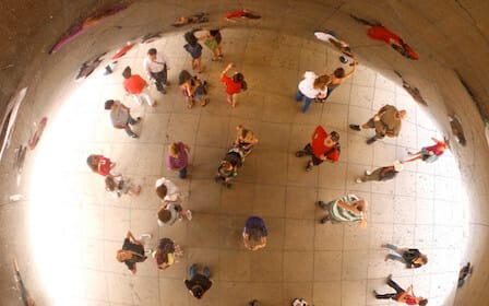 Reflection of people in the Cloudgate sculpture in Chicago