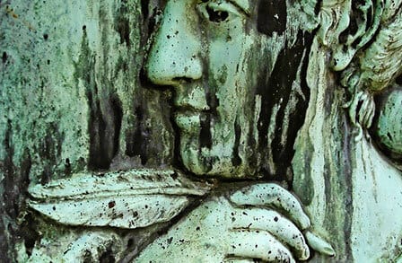 Image of a statue holding a quill