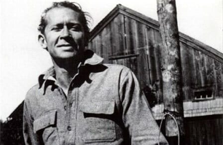 Photo of E. E. Cummings in front of a barn