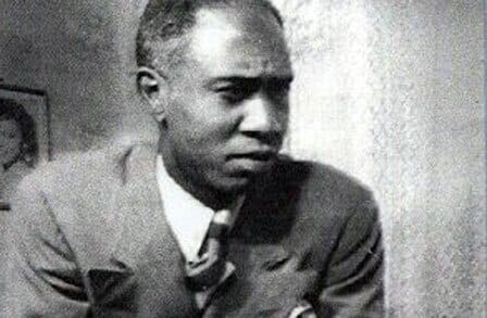 Black and white headshot of poet Melvin Tolson in a suit.