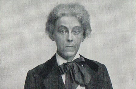 Grainy black and white portrait of poet Charlotte Mew