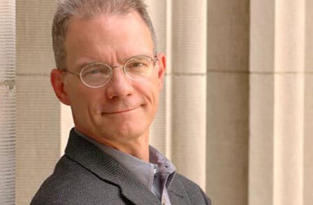 Headshot of poet Kevin Stein in a grey suit.