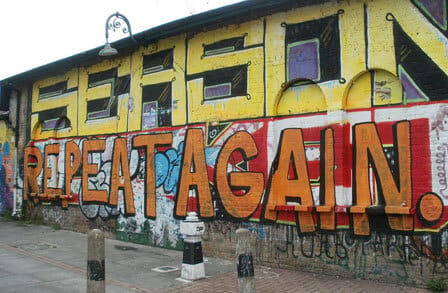 Image of "Season Repeat Again!" graffitied onto a building