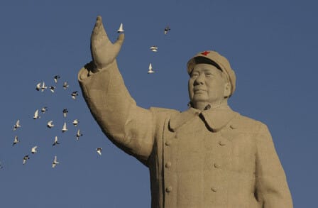 Image of a statue of Mao Zedong with birds