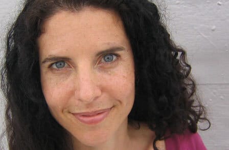 Headshot of writer Susan Hutton in a magenta shirt.