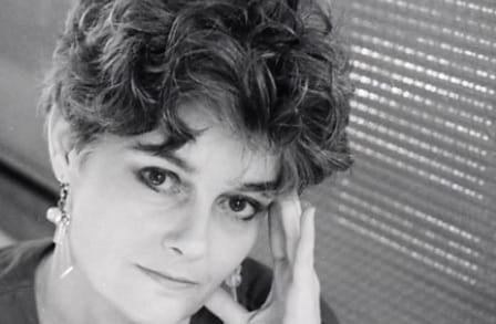 Headshot of poet Kelly Cherry, resting head in hand.