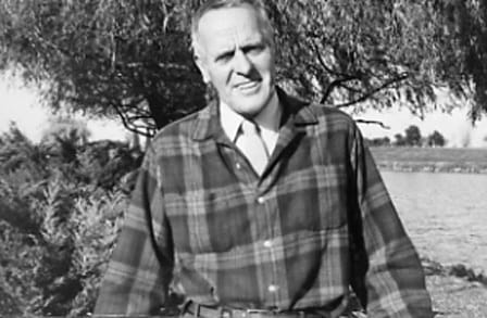 Poet John Dickson outside in front of a tree.