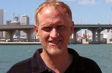 Headshot of Campbell McGrath across the water from the skyline.