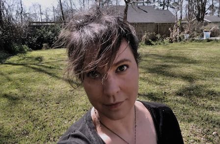 Headshot of poet Jennifer Reeser outside in front of a house.