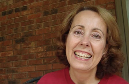 Headshot of poet Catherine Field in front of a brick wall.