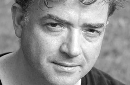 Black and white headshot of poet Glyn Maxwell.