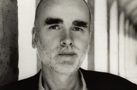 Black and white headshot of poet Adam Zagajewski.