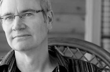 Headshot of poet Michael Chitwood in a chair.