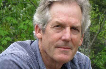 Headshot of poet Michael Collier outdoors.