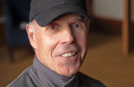 Headshot of writer Bruce Smith in a baseball cap.