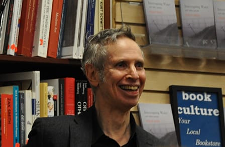 Headshot of writer Philip Fried in front of a bookshelf at a bookstore.