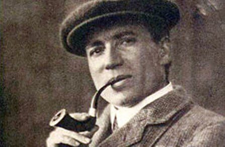 Headshot of poet William H. Davies, with a pipe.