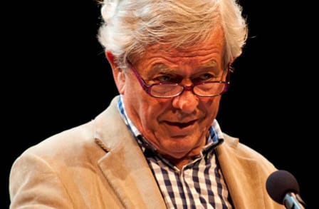 Australian poet Chris Wallace-Crabbe at a microphone.