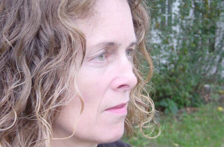 Side profile of poet Deborah Warren outdoors.