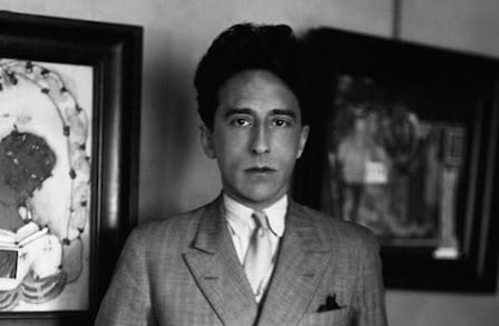 Headshot of writer Jean Cocteau in a suit.
