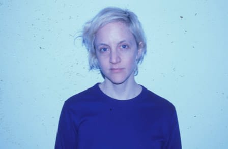 Blue lit headshot of writer Cynthia Cruz