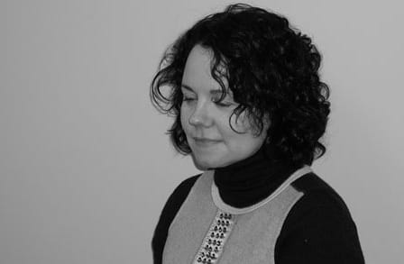 Black and white headshot of poet Averill Curdy.
