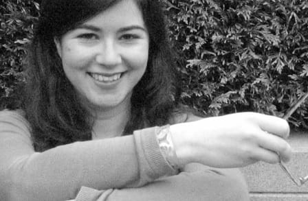 Black and white headshot of writer Rebecca Hoogs outdoors.