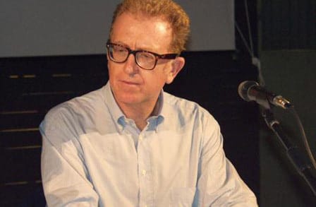 Poet Valerio Magrelli at a microphone.