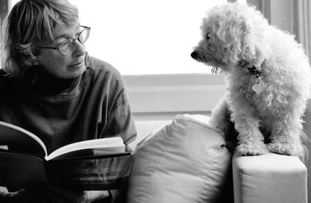 Mary Oliver reading with a dog
