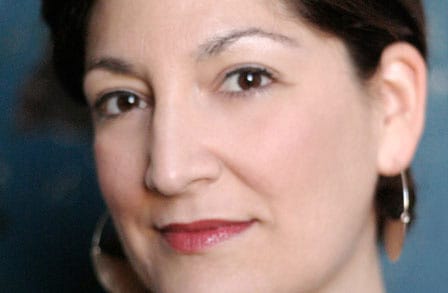 Headshot of poet Robin Ekiss, in red lipstick.