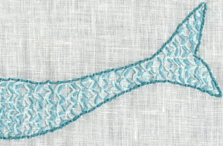 Image of a mermaid's tail against a grey background in cloth