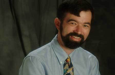 Headshot of writer Robert Pottle in a button down and tie.