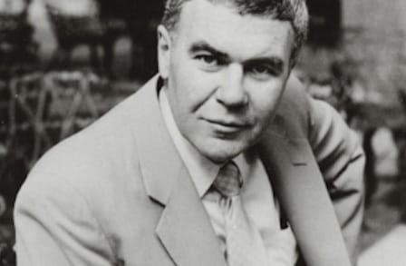 Writer Raymond Carver outdoors in a suit.