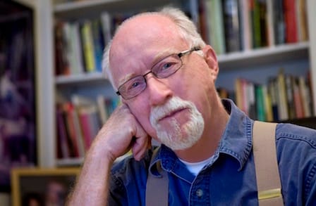 Headshot of poet William Trowbridge in front of a bookshelf.