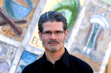 Color photograph of art historian, curator and editor Roberto Tejada