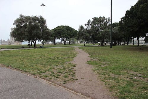 A foot-worn path through a grass park.