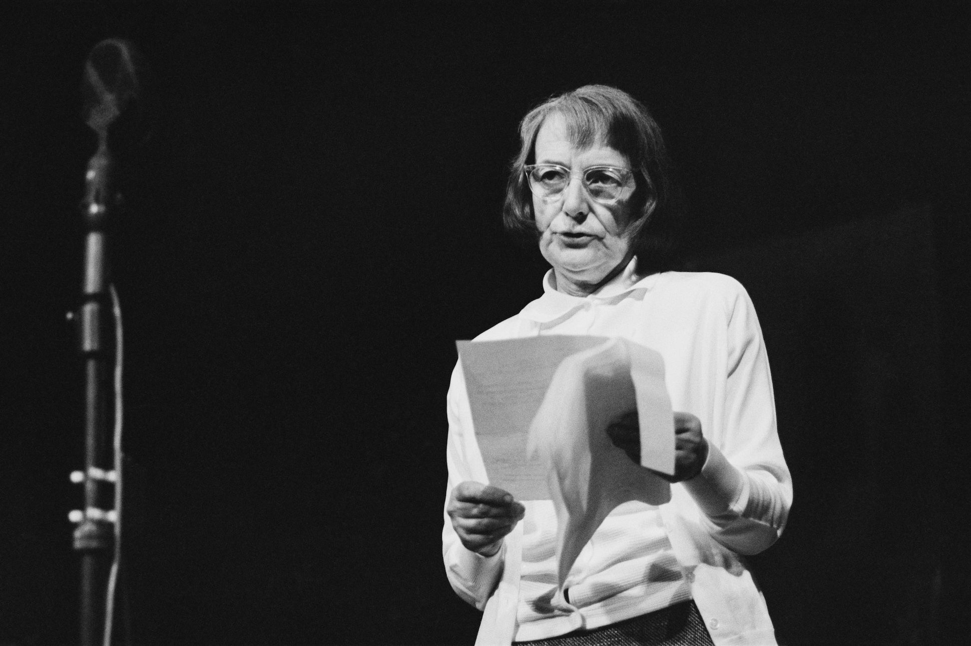 English poet and novelist Stevie Smith (1902 - 1971) reading a poem at a Poetry Festival held at the Royal Court Theatre, London, UK, July 15th to 20th, 1963.