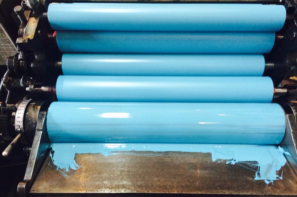 Bright blue ink on printing rollers.