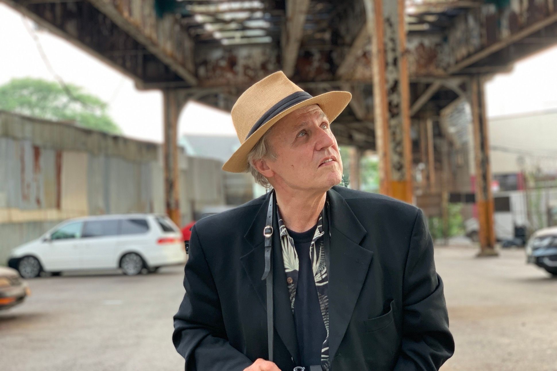 Photo of poet Gerard Malanga under Dyre Av El, Bronx
