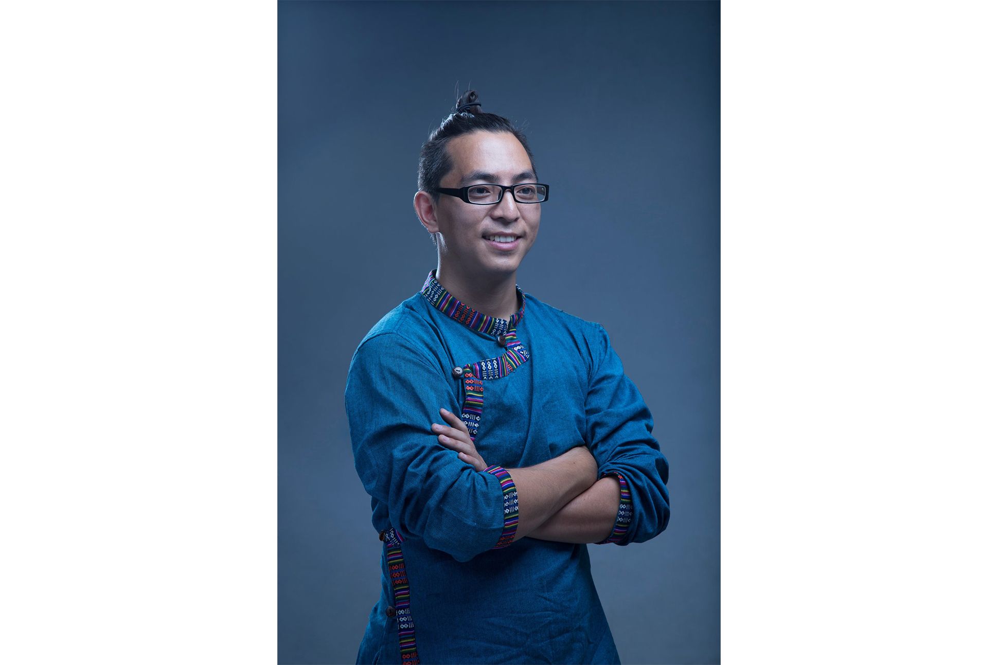Samyak Shertok, a Tamang man in a traditional attire, his hands crossed over his chest.