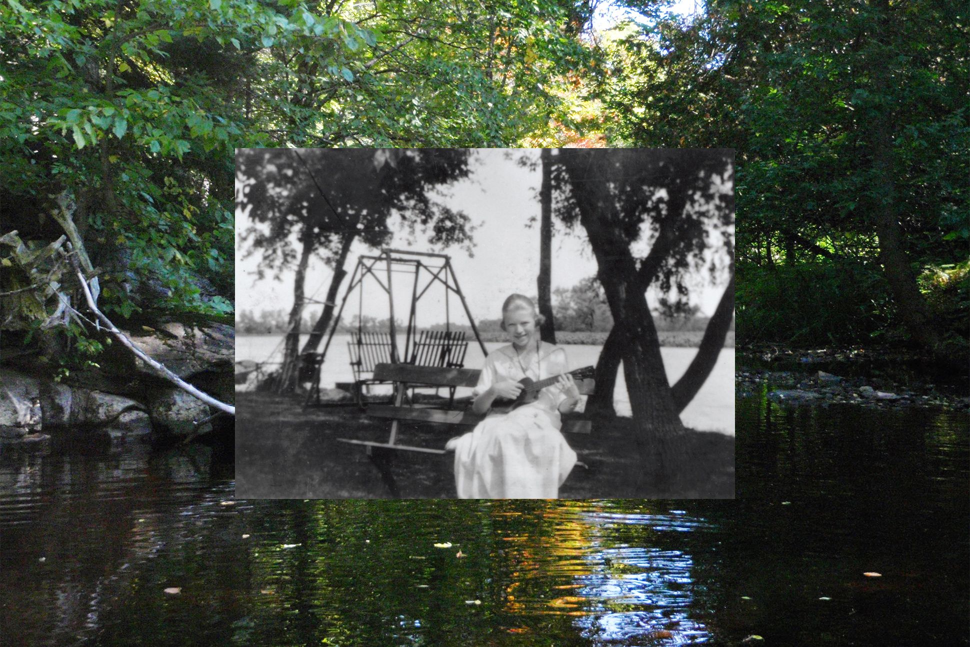 Lorine Niedecker sitting by a lake playing the ukelele.