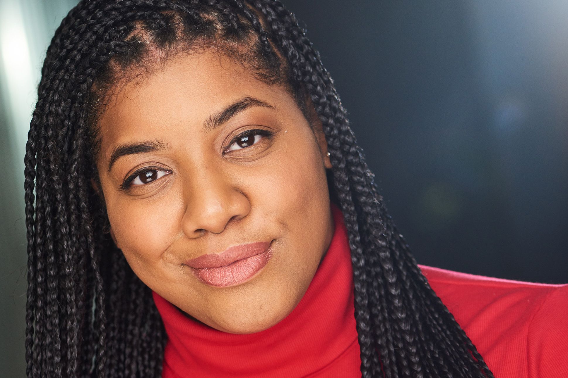 Close up photograph of Ashley August in a red turtleneck