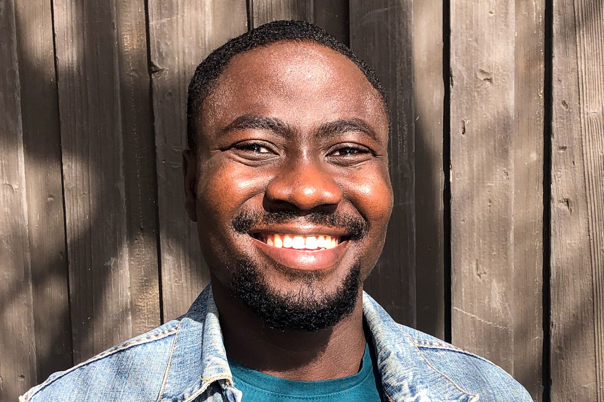 A black man smiling in the sun