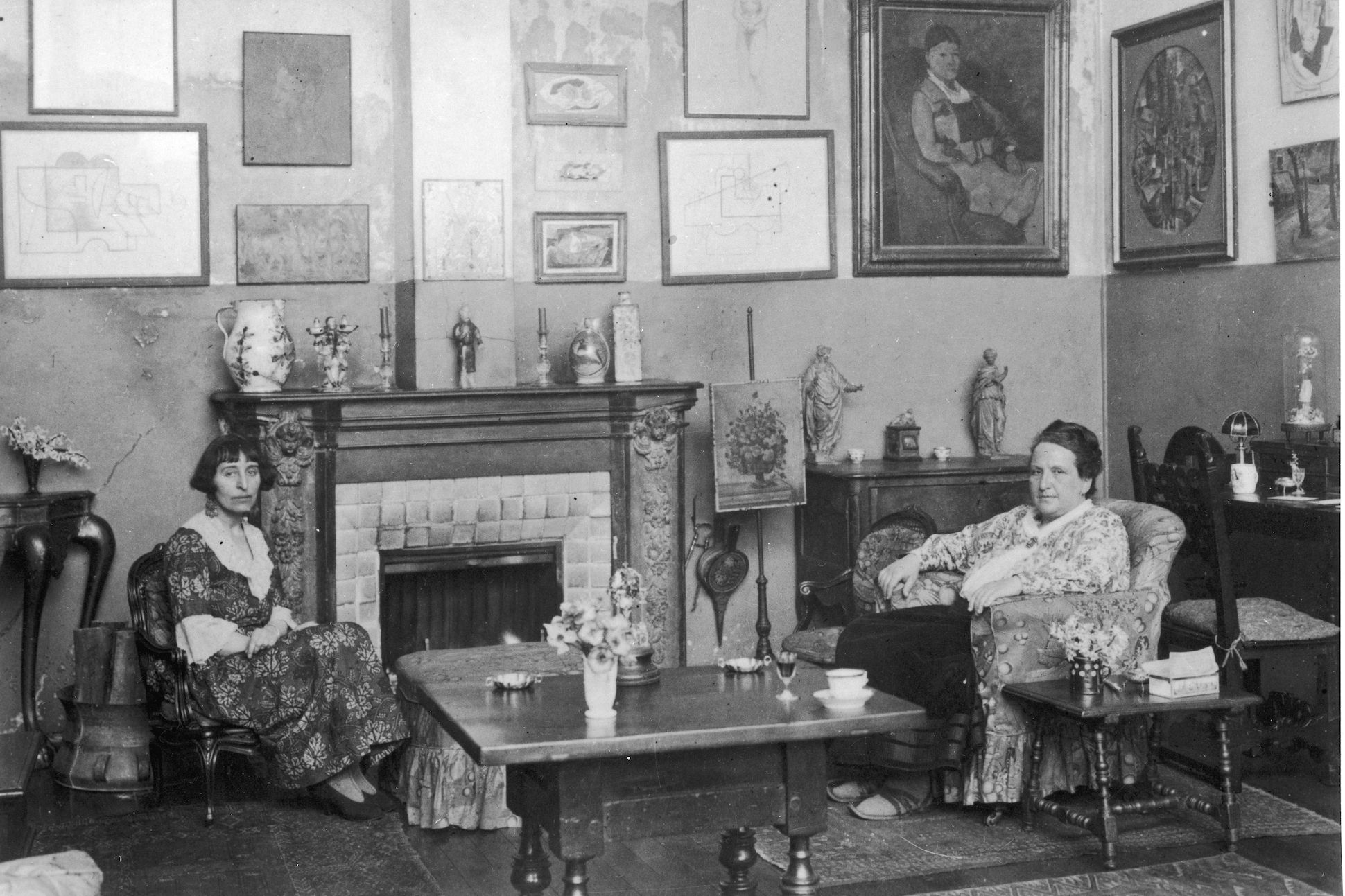 Gertrude Stein (right) and Alice B. Toklas sitting looking at camera, circa 1940s.