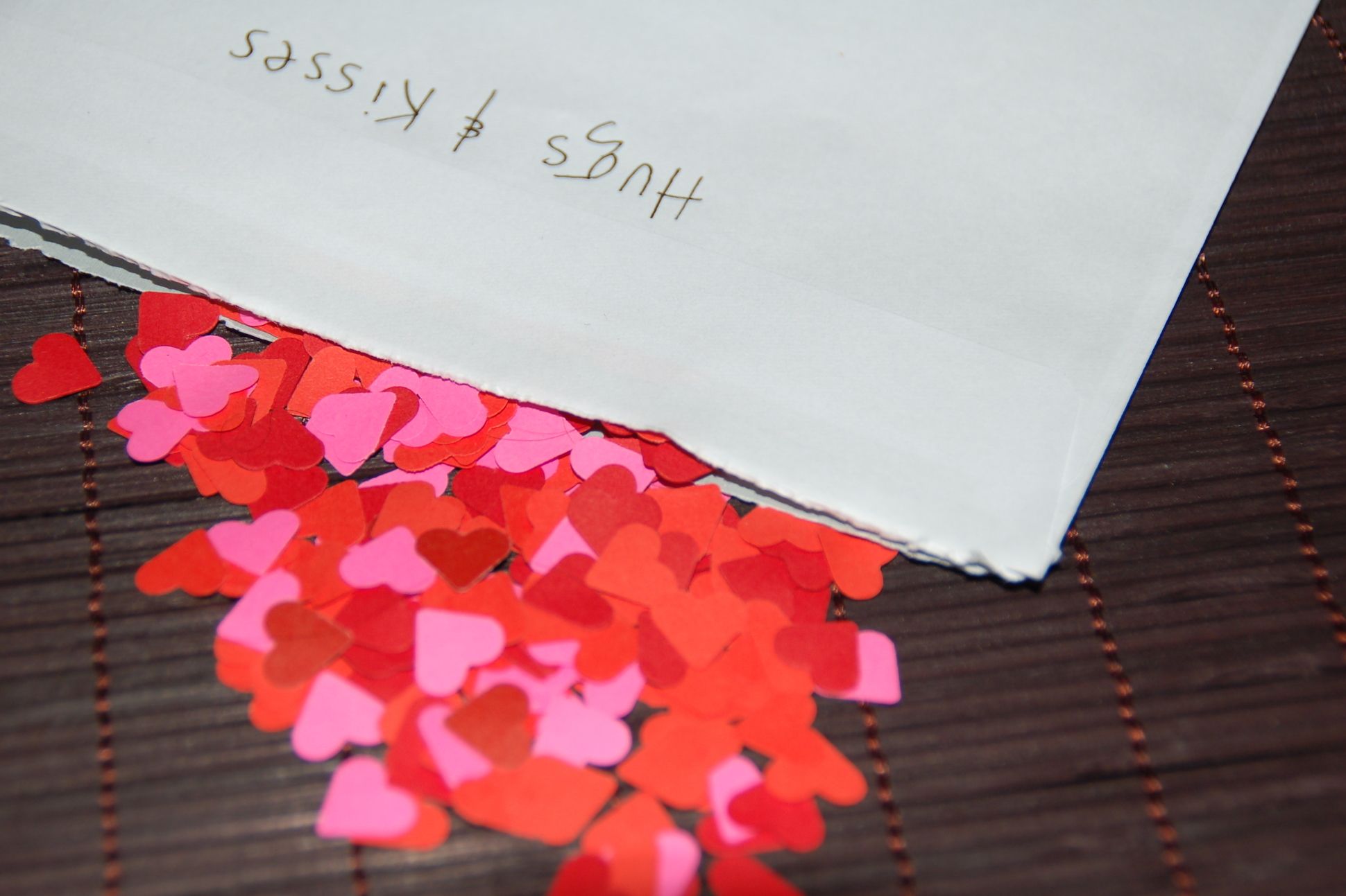 Image of an envelope overflowing with paper hearts.