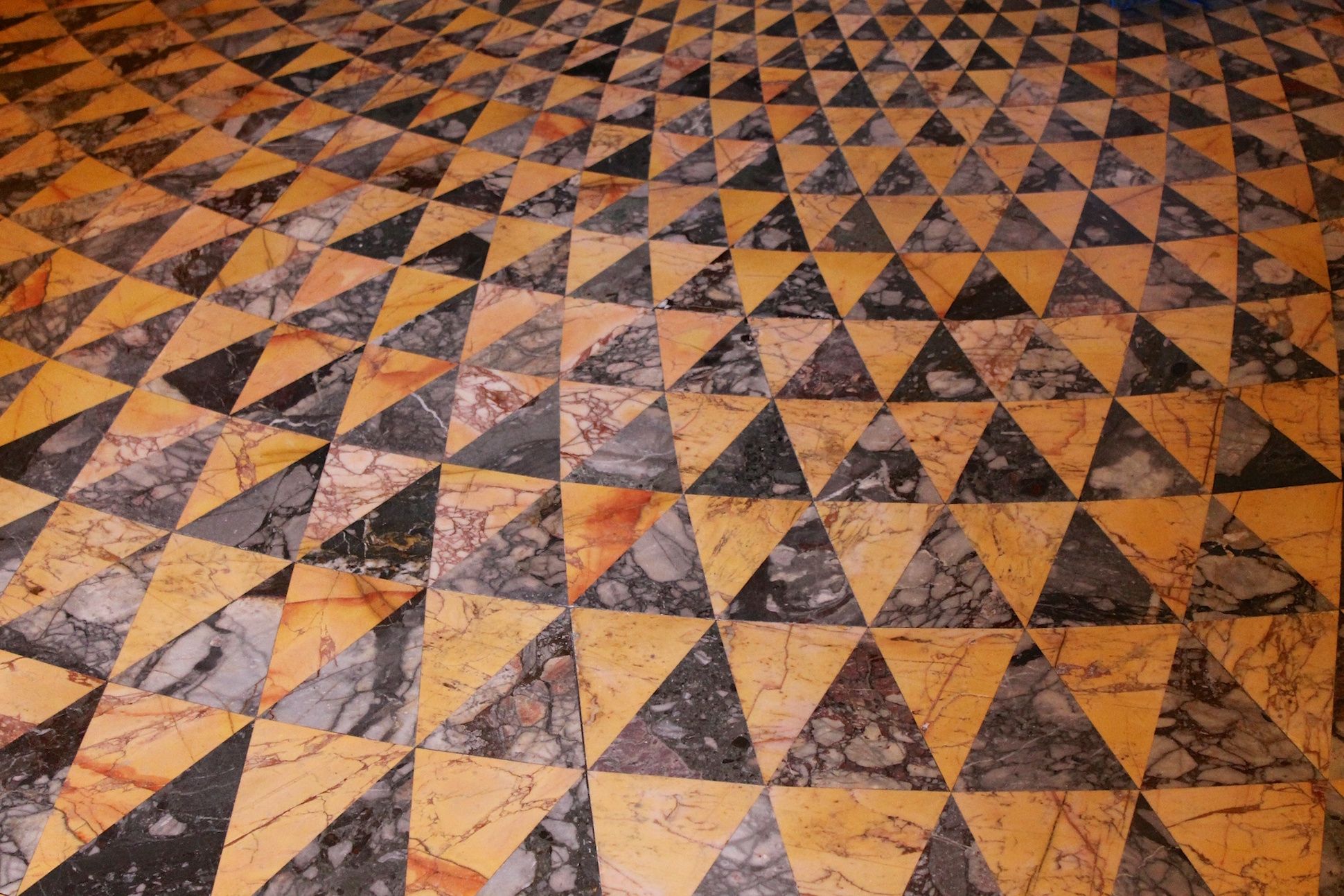 Image of triangle pattern engraved on a marble floor