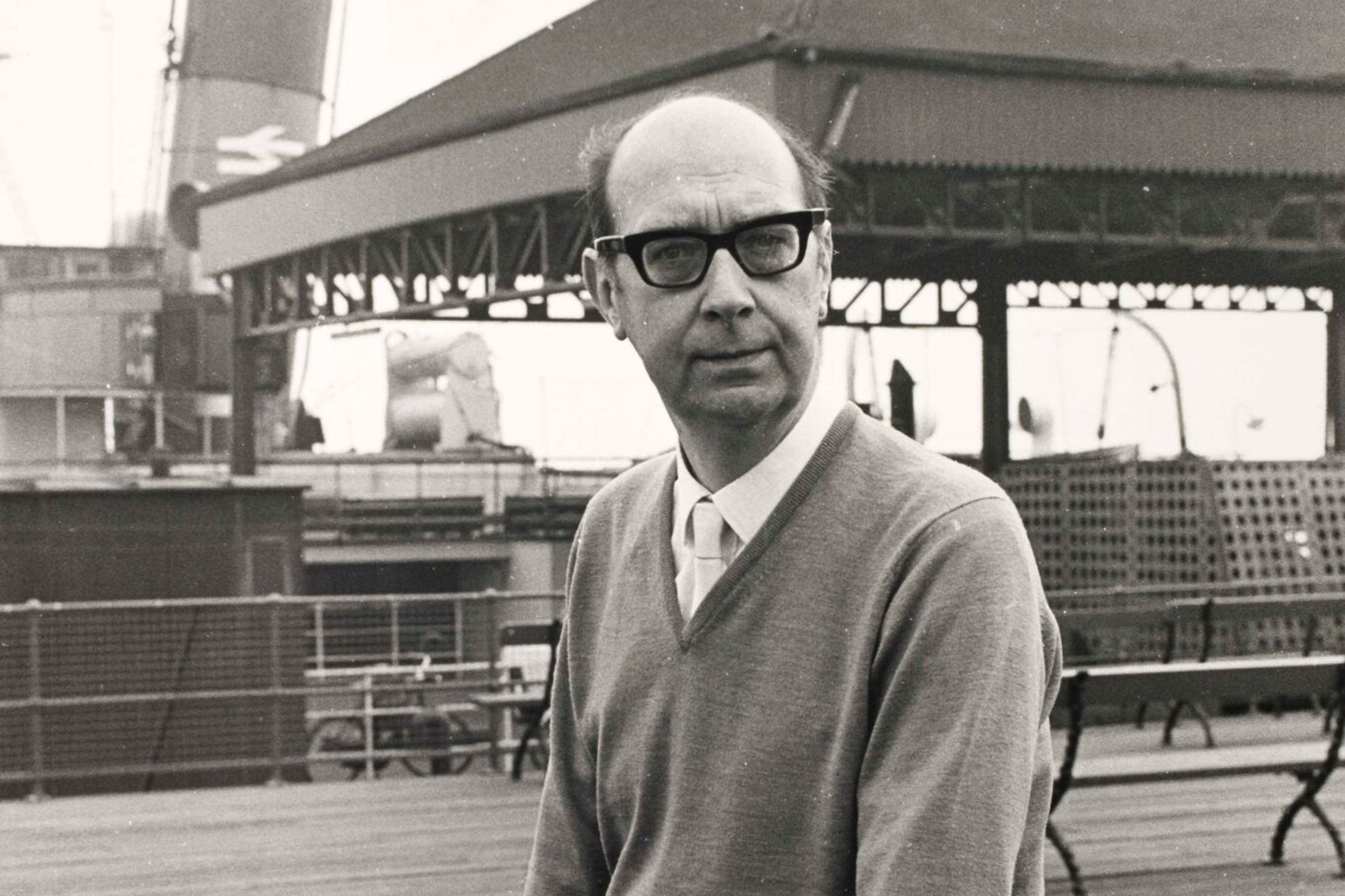 Black and white medium shot portrait of poet Philip Larkin.