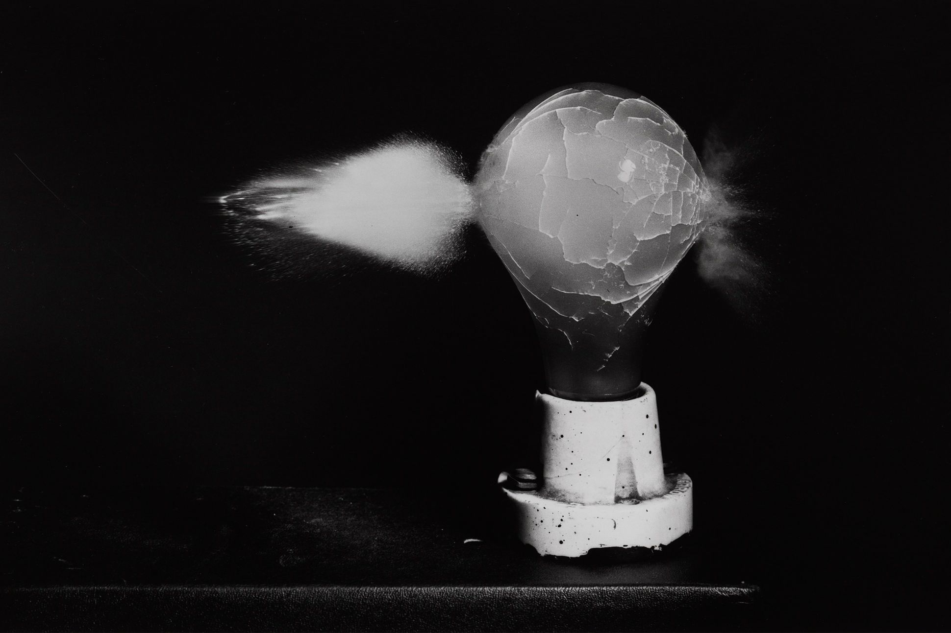 Black-and-white photograph of a lightbulb exploding.
